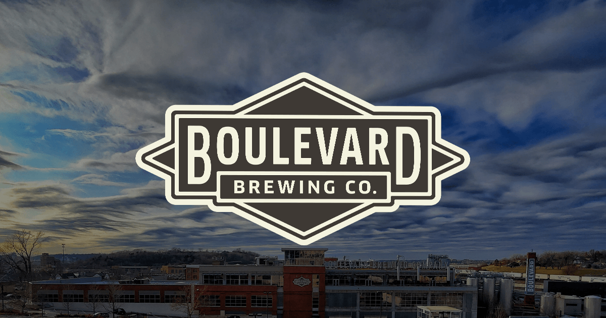 A large logo reading "Boulevard Brewing Co." is centered over a backdrop of an industrial brewery complex with red brick buildings under a dramatic sky filled with swirling clouds.
