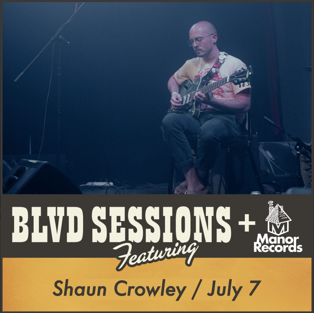 A musician is seated and playing guitar on a stage with a dark background. Text overlay reads "BLVD SESSIONS Featuring Shaun Crowley / July 7" next to "Manor Records" logo.