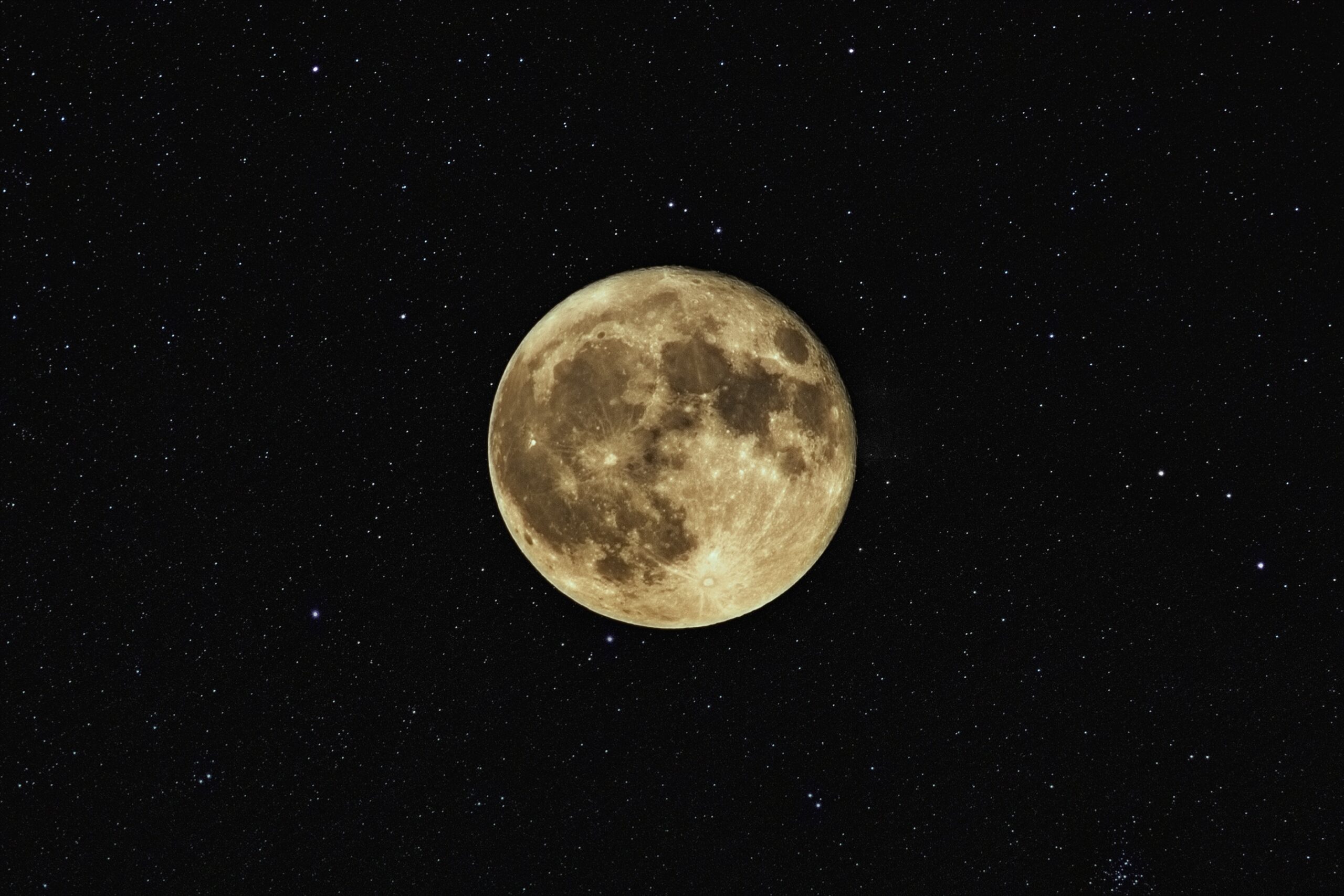 A bright full moon against a dark night sky filled with scattered stars. The moon's surface details are clearly visible, highlighting its craters and shadows.