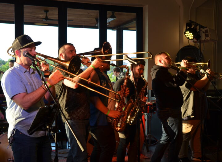A group of musicians playing brass instruments