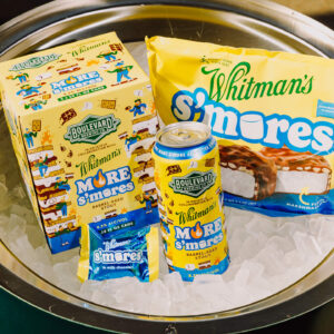 A can of Boulevard Brewing Co. Whitman’s S’mores Beer, a Whitman’s S’mores ice cream bar, a Whitman’s S’mores ice cream sandwich, and their packaging sit on a bed of ice.