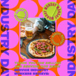 A person holds a glass of beer next to a table with fresh pizza. Celebrate Industry Day with 25% off in the gift shop and 50% off in the beer hall for service industry workers. Bright, colorful design.