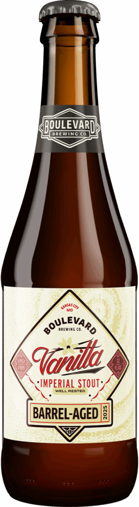 A brown glass bottle of Boulevard Brewing Co. Vanilla Imperial Stout, labeled "Barrel-Aged" with cream, red, and gold accents and a black cap. The label highlights vanilla flavor and the year 2023.