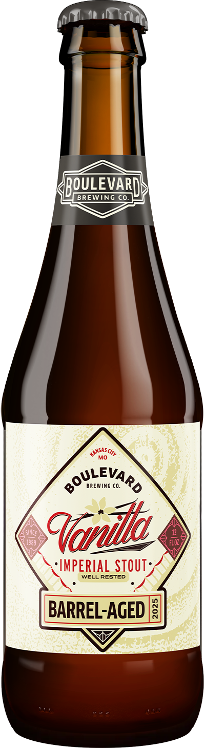A brown glass bottle of Boulevard Brewing Co. Vanilla Imperial Stout, labeled "Barrel-Aged" with cream, red, and gold accents and a black cap. The label highlights vanilla flavor and the year 2023.