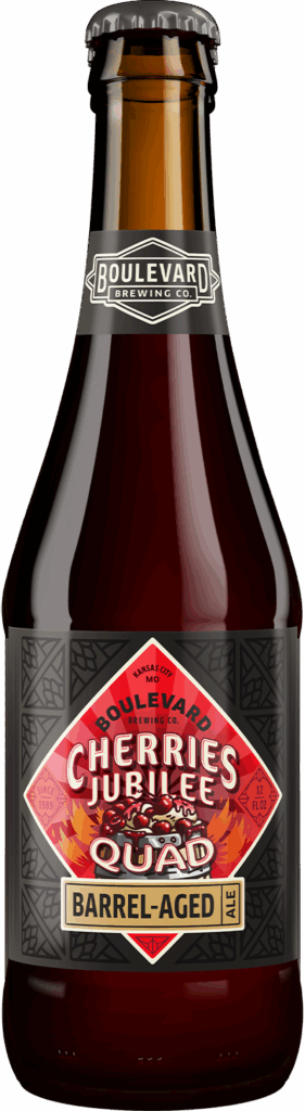 A brown glass bottle of Boulevard Brewing Co.'s Cherries Jubilee Quad Barrel-Aged Ale, featuring a red, black, and gold label with geometric patterns and bold text.