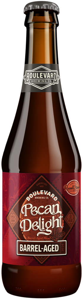 A brown glass bottle of Boulevard Brewing Co. Pecan Delight Barrel-Aged beer, featuring a red label with decorative text and details, and a black cap with the brewery’s logo.